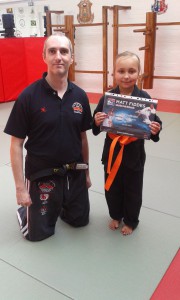 Isobel Moore gaining her orange belt in Matt Fiddes Junior Champs